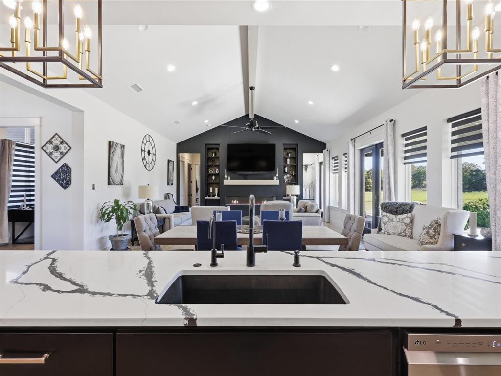 2016 Sonora Way Poolville, TX 76487 - Photo 10 of 40 a view of living room with kitchen island furniture and a flat screen tv