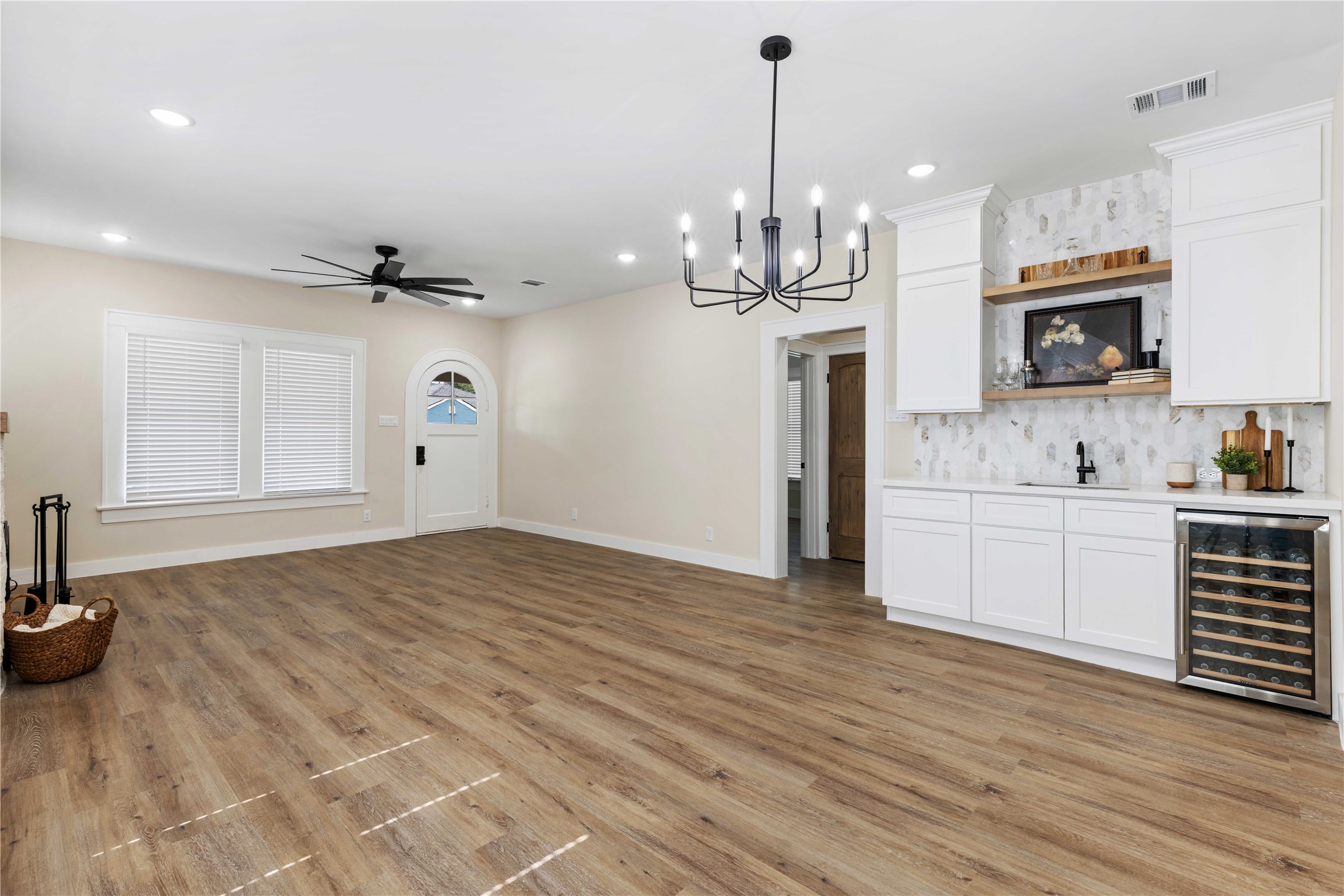 908 Key Street Houston, TX 77009 - Photo 12 of 29 High ceilings, LVP flooring, and wet bar and built-ins, and restored 1920 front door
