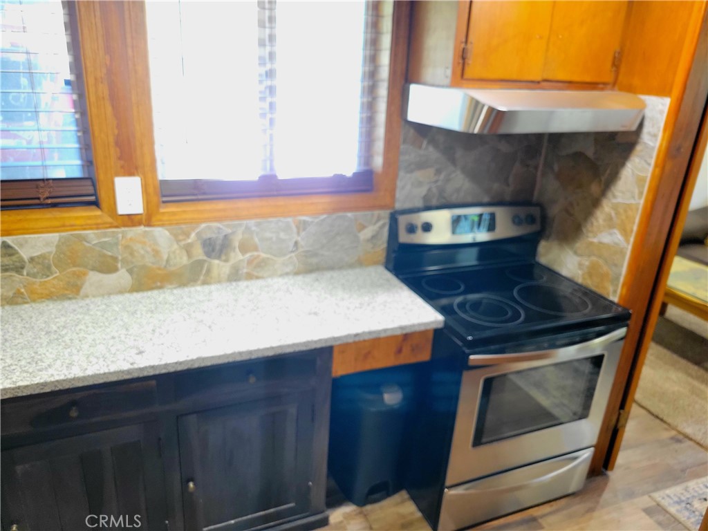 1116 Lark Road Wrightwood, CA 92397 - Photo 34 of 46 a kitchen with a stove and a microwave
