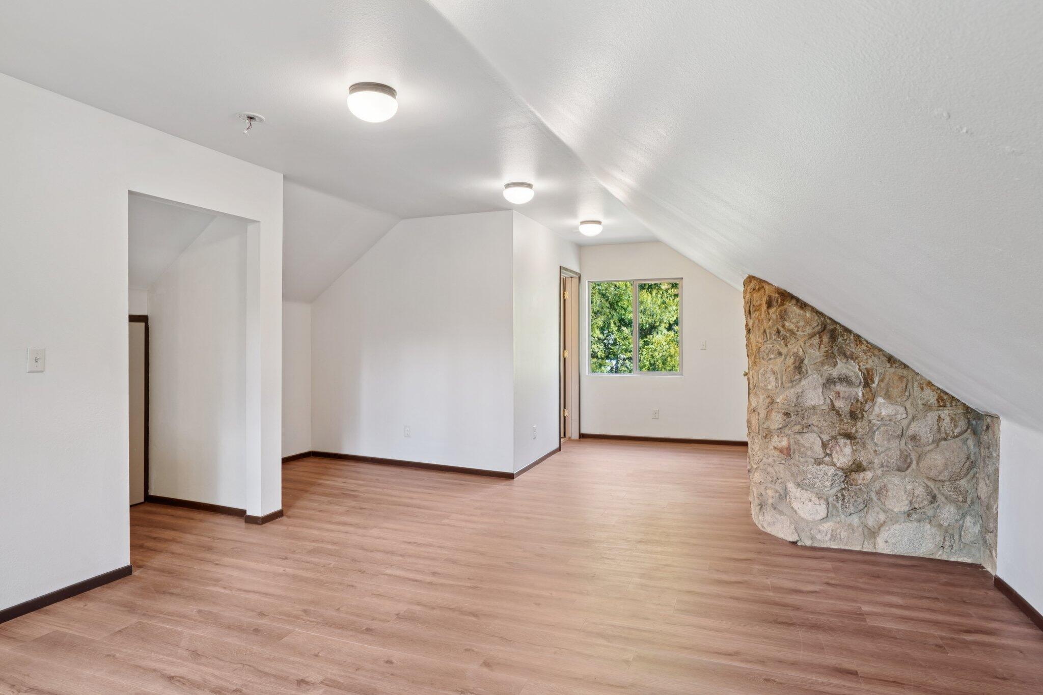 25140 Lodge Road Idyllwild, CA 92549 - Photo 21 of 35 a view of an empty room with wooden floor and a window