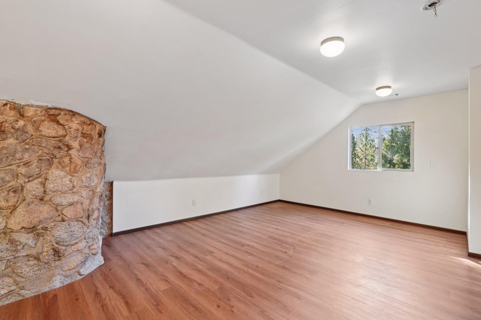 25140 Lodge Road Idyllwild, CA 92549 - Photo 22 of 35 an empty room with wooden floor and windows