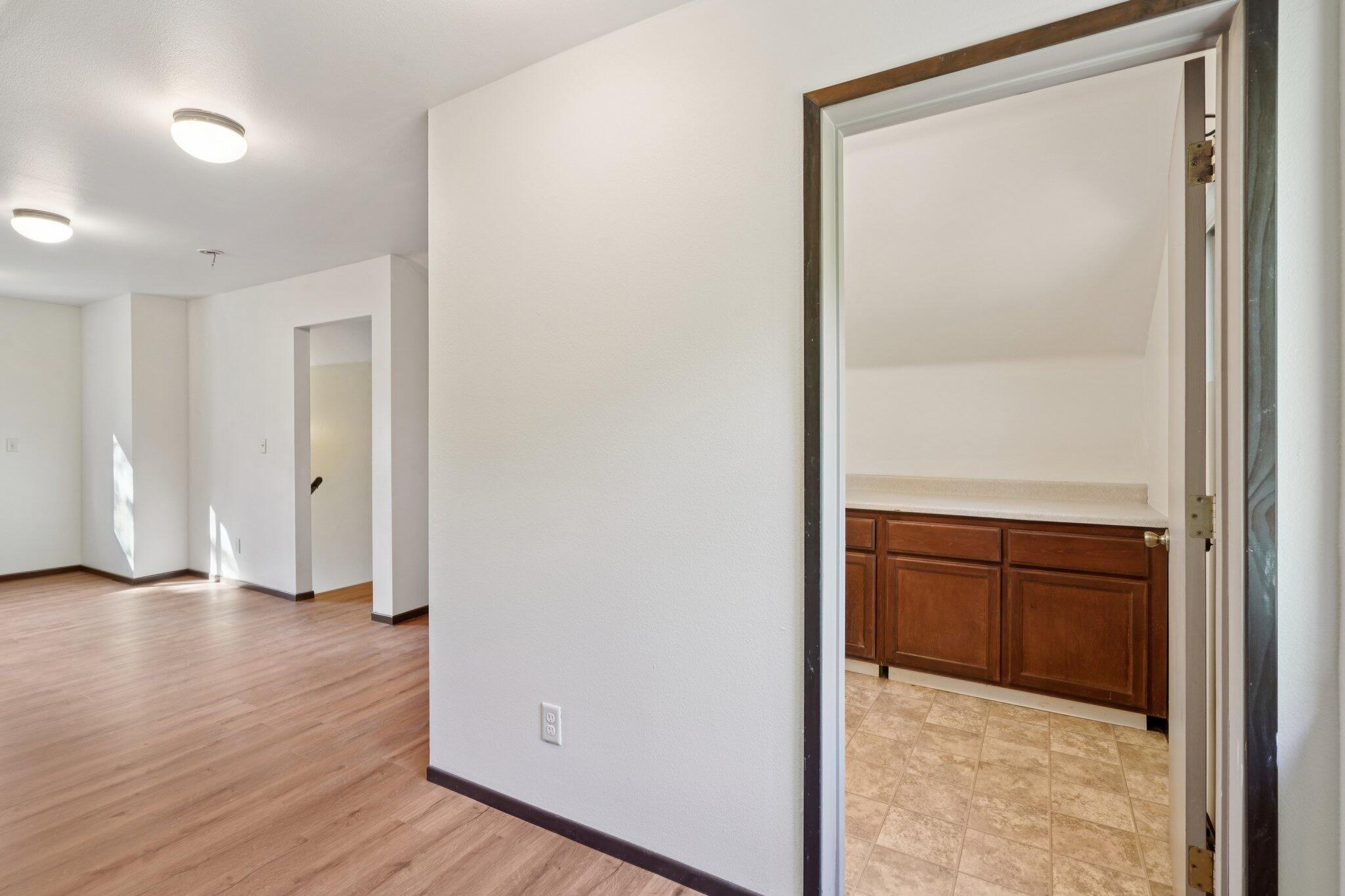 25140 Lodge Road Idyllwild, CA 92549 - Photo 24 of 35 an empty room with wooden floor and cabinet