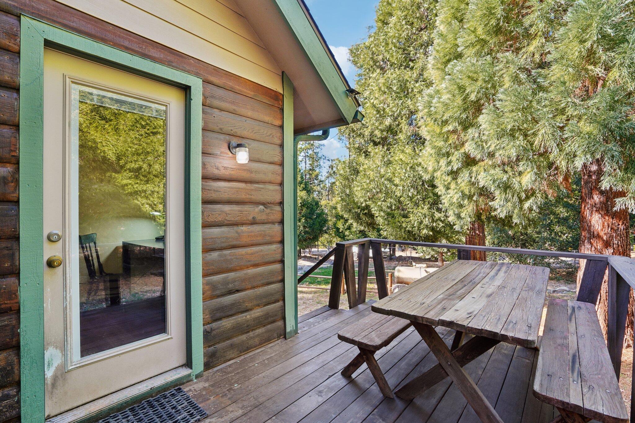 25140 Lodge Road Idyllwild, CA 92549 - Photo 4 of 35 a view of balcony with wooden floor and outdoor seating