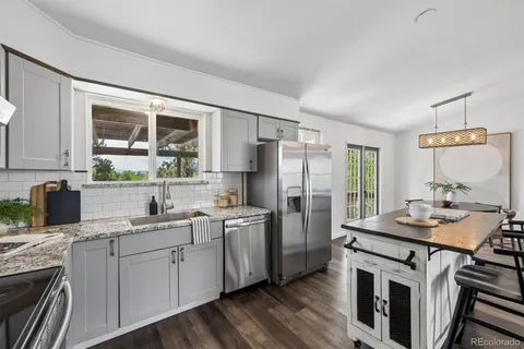 a kitchen with a sink stove and refrigerator