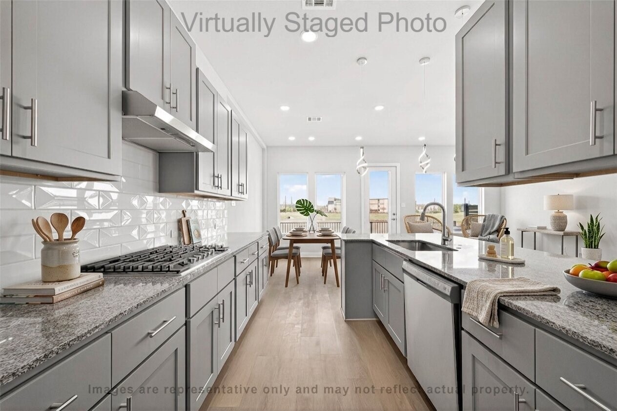 10719 Mason Road, Unit 39 Richmond, TX 77406 - Photo 10 of 50 Virtual Staging - Modern kitchen featuring gray cabinetry, granite countertops, and an open layout flowing into a sunlit dining area with large windows