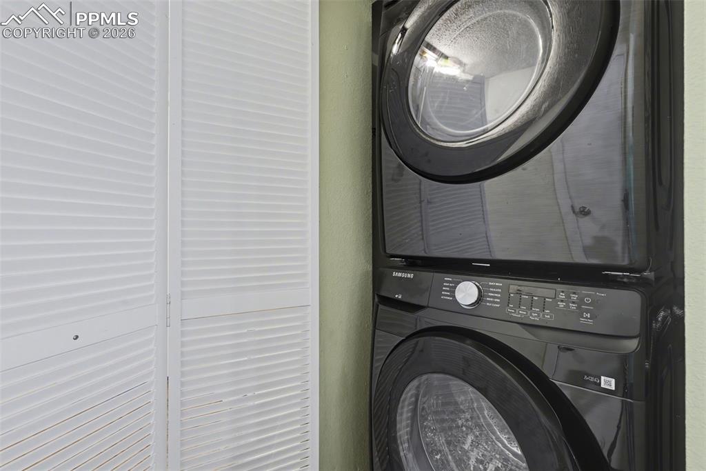 10145 Chipita Park Road Cascade, CO 80809 - Photo 19 of 33 Laundry area with stacked washer and clothes dryer