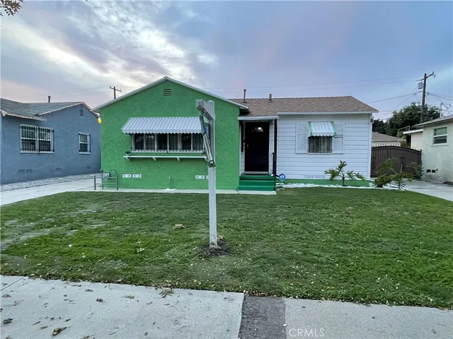 a backyard of a house with table and chairs