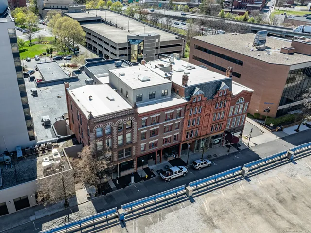 a roof deck with table and chairs