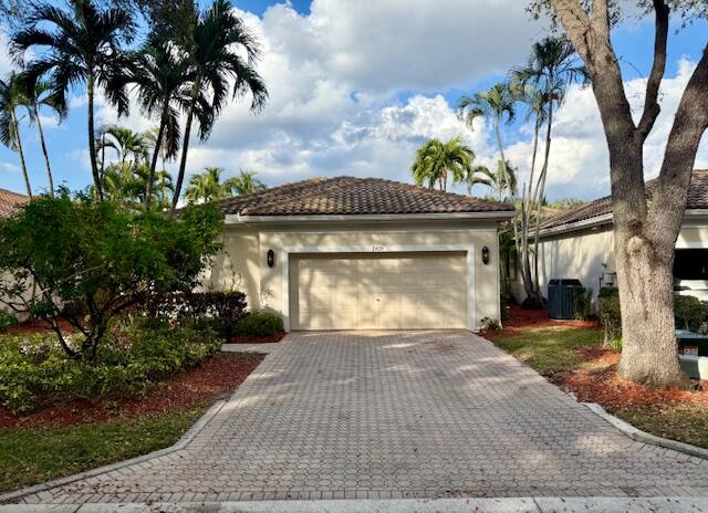 2409 Northwest 66th Drive Boca Raton, FL 33496 - Photo 13 of 15 a front view of a house with a garden