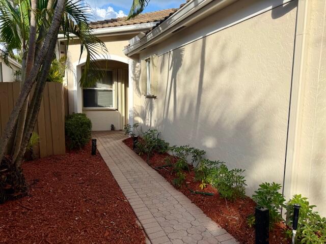 2409 Northwest 66th Drive Boca Raton, FL 33496 - Photo 2 of 15 a front view of a house with a yard