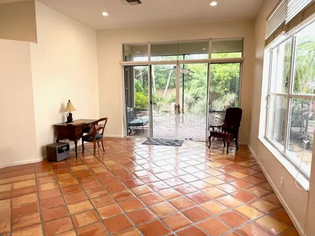 a living room with furniture floor to ceiling window and a floor to ceiling window