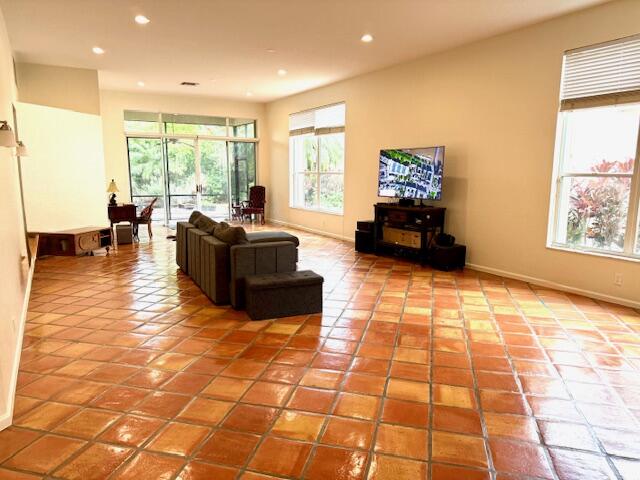 2409 Northwest 66th Drive Boca Raton, FL 33496 - Photo 10 of 15 a living room with furniture floor to ceiling window and a floor to ceiling window