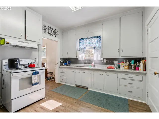 a kitchen with cabinets appliances and white wooden cabinets