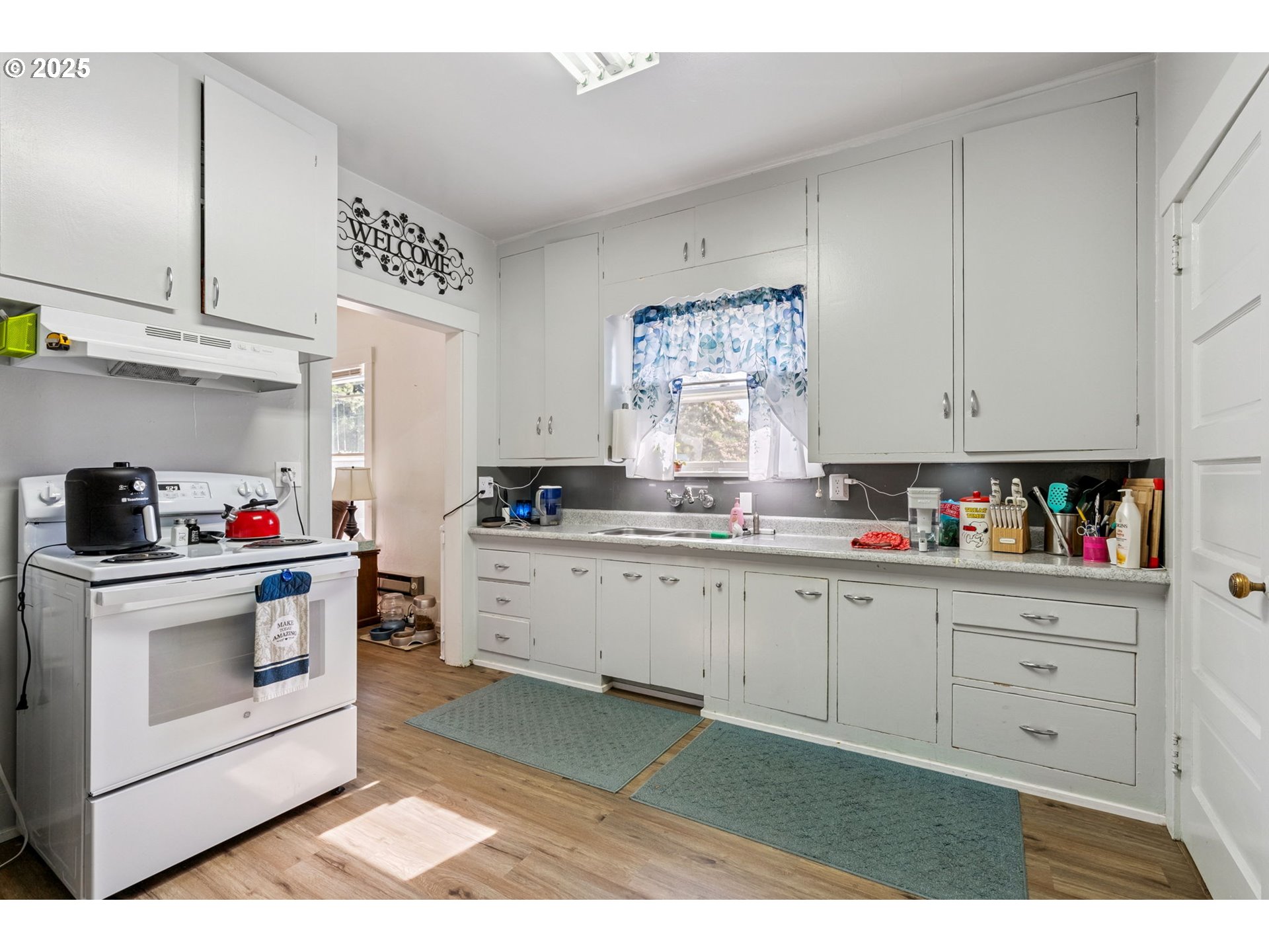 1108 9th Street Hood River, OR 97031 - Photo 24 of 44 a kitchen with cabinets appliances and white wooden cabinets