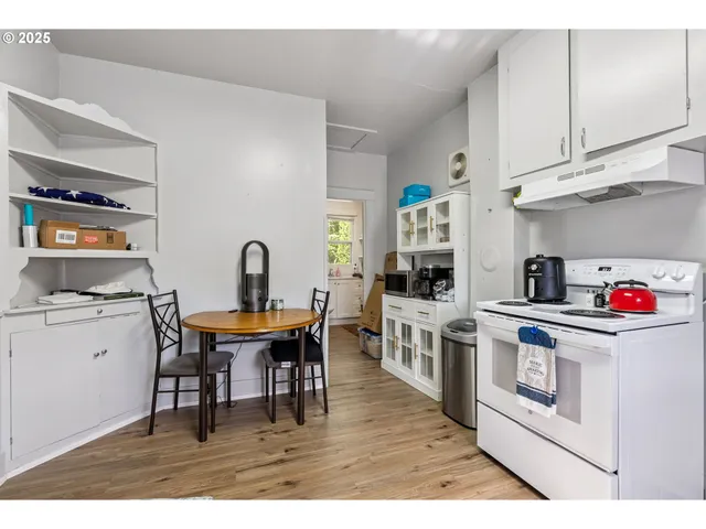 a kitchen with stainless steel appliances granite countertop a white cabinets and stove top oven