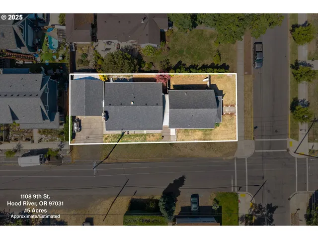 an aerial view of a house with a yard