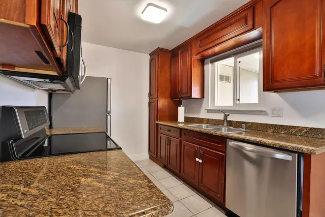 a living room with furniture a mirror a lamp and a window