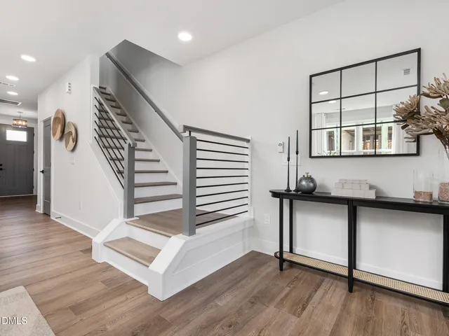 a view of entryway with wooden floor and stairs