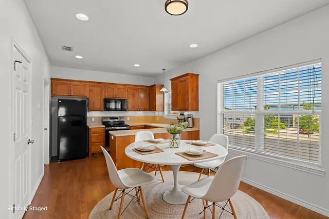 a kitchen with a table and chairs in it