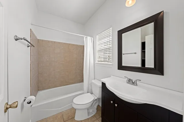 a bathroom with a double vanity sink toilet mirror and bathtub