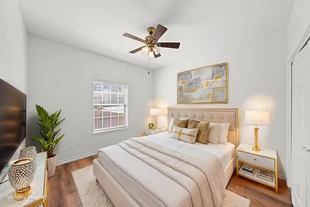 a bedroom with a large bed and a window