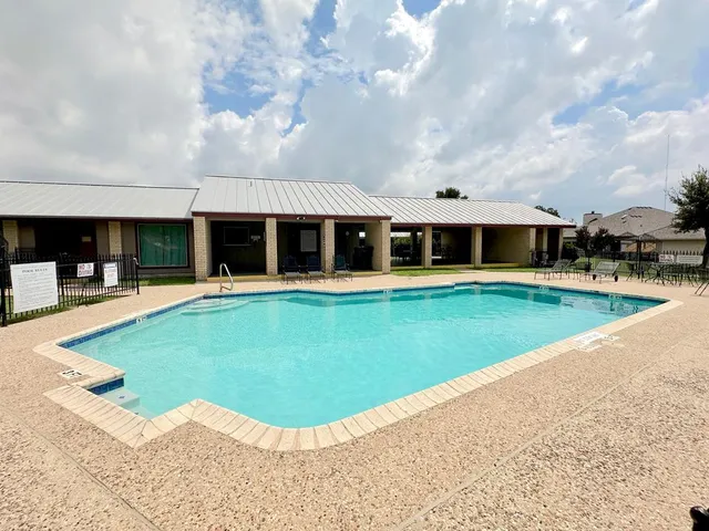 a view of a house with swimming pool and yard