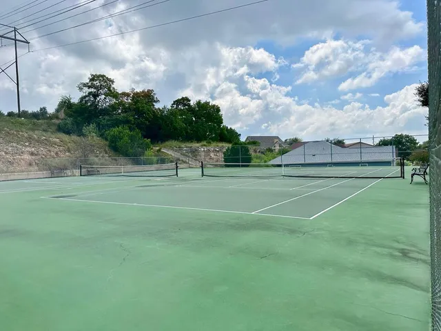 a view of a playground with basketball court
