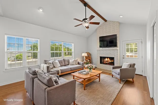 a living room with furniture a fireplace and a flat screen tv
