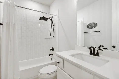 a bathroom with a sink a toilet and a bathtub