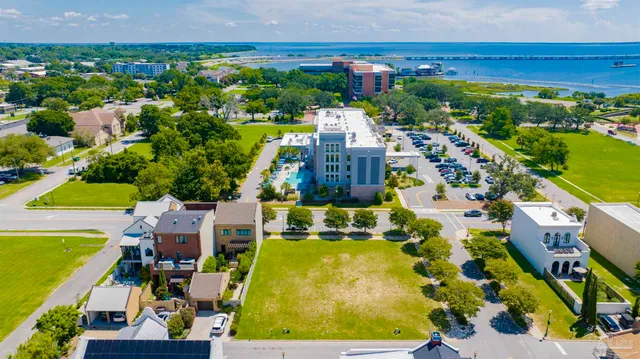 an aerial view of a house with a swimming pool outdoor seating and yard
