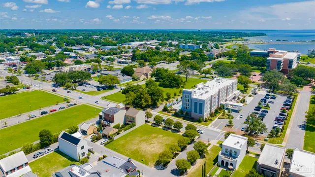 an aerial view of a house with a swimming pool outdoor seating and yard