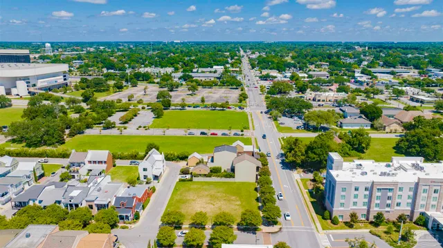 an aerial view of residential houses with outdoor space and swimming pool
