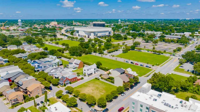 an aerial view of residential houses with outdoor space and swimming pool