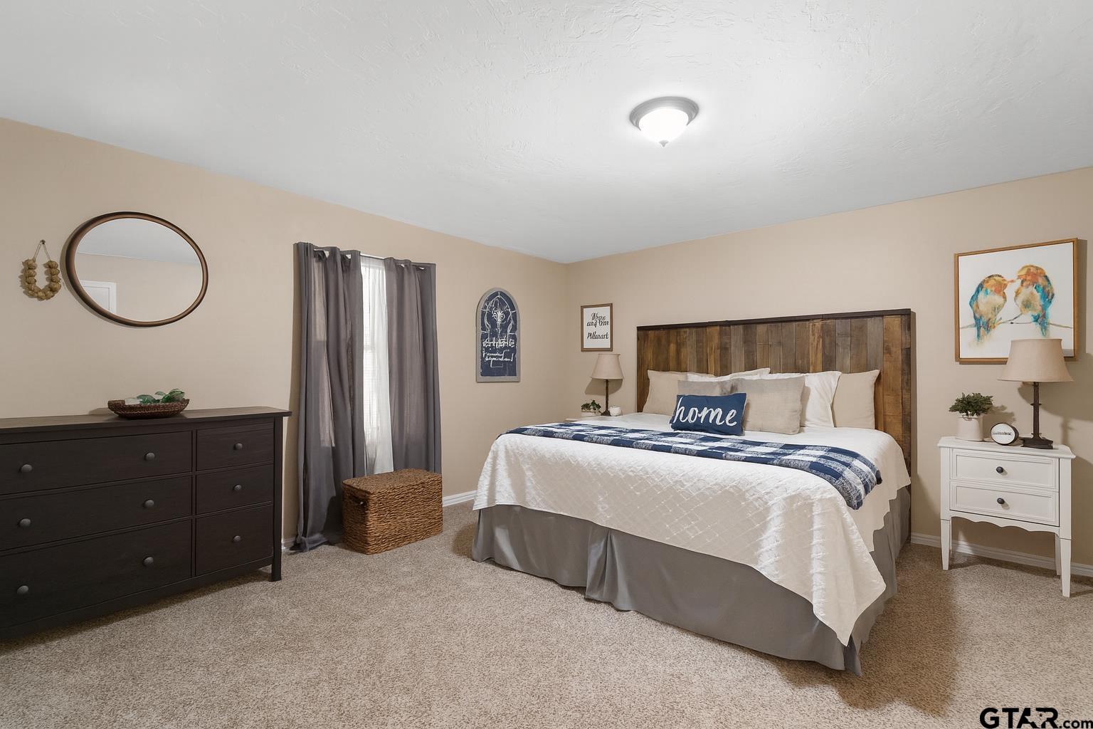 1832 FM 2906 Longview, TX 75603 - Photo 14 of 42 a bedroom with a bed and a dresser