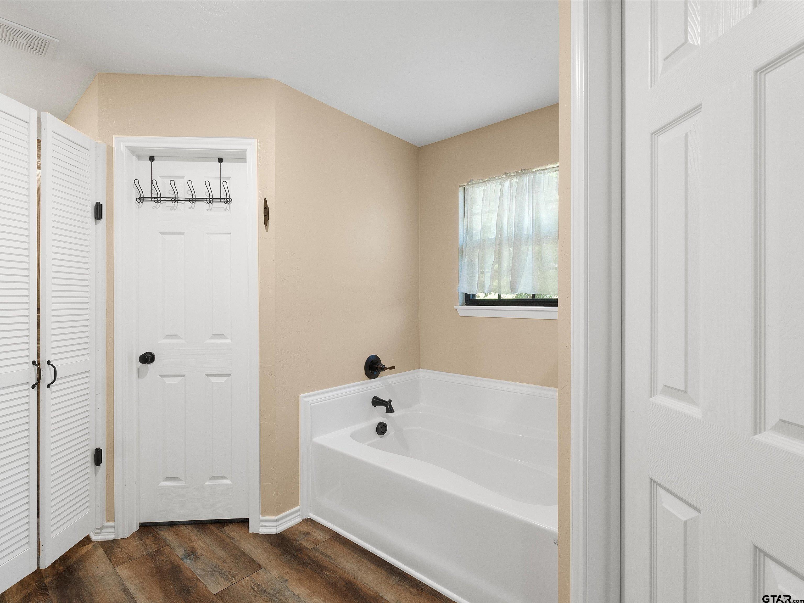 1832 FM 2906 Longview, TX 75603 - Photo 16 of 42 a white bath tub sitting next to a white cabinet