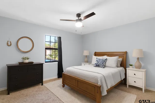 a bedroom with a bed and a chandelier