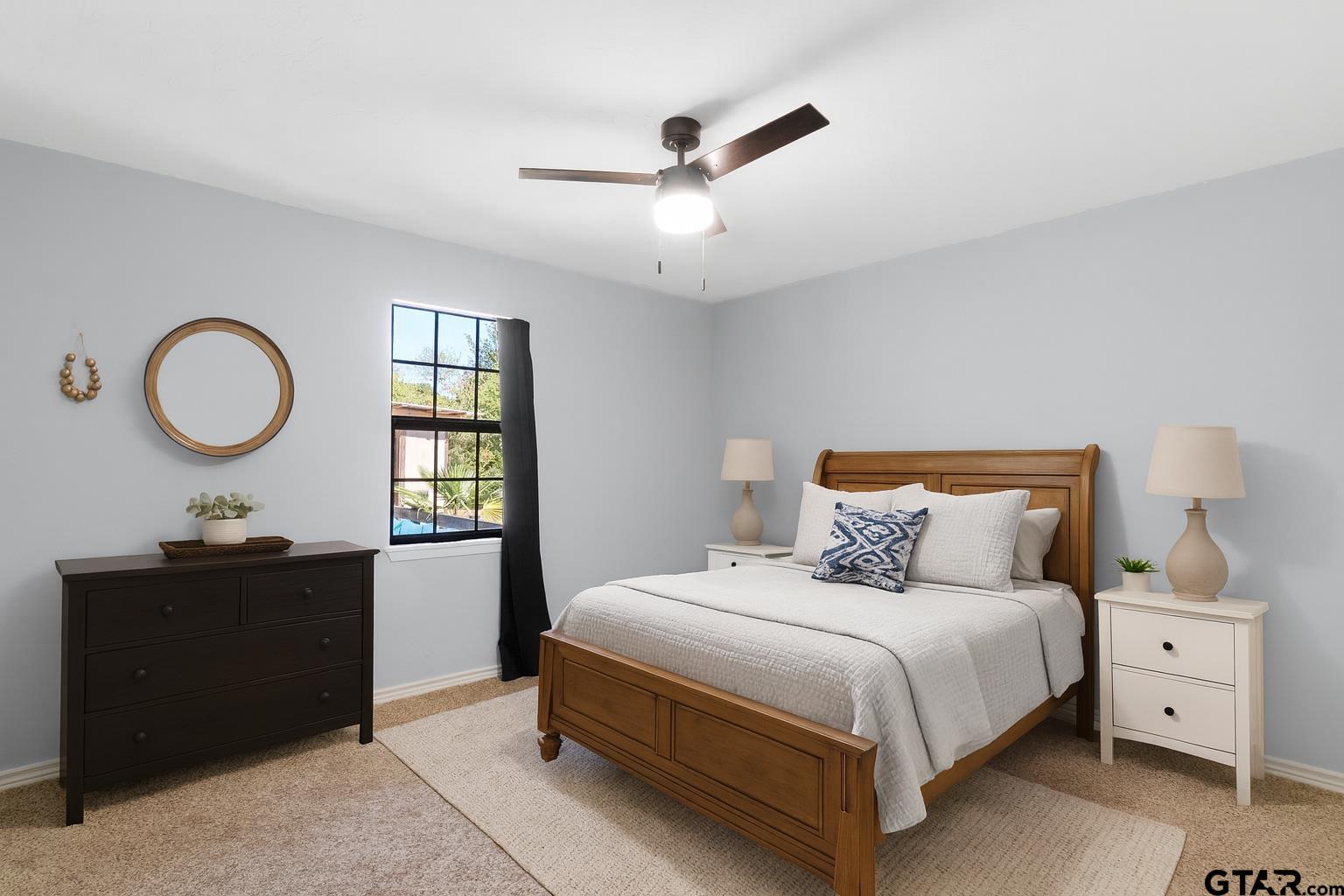 1832 FM 2906 Longview, TX 75603 - Photo 18 of 42 a bedroom with a bed and a chandelier