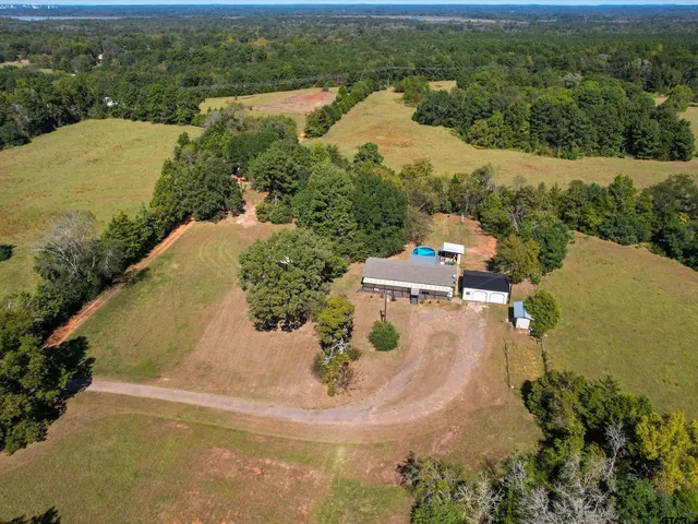 an aerial view of a house with yard swimming pool and outdoor seating