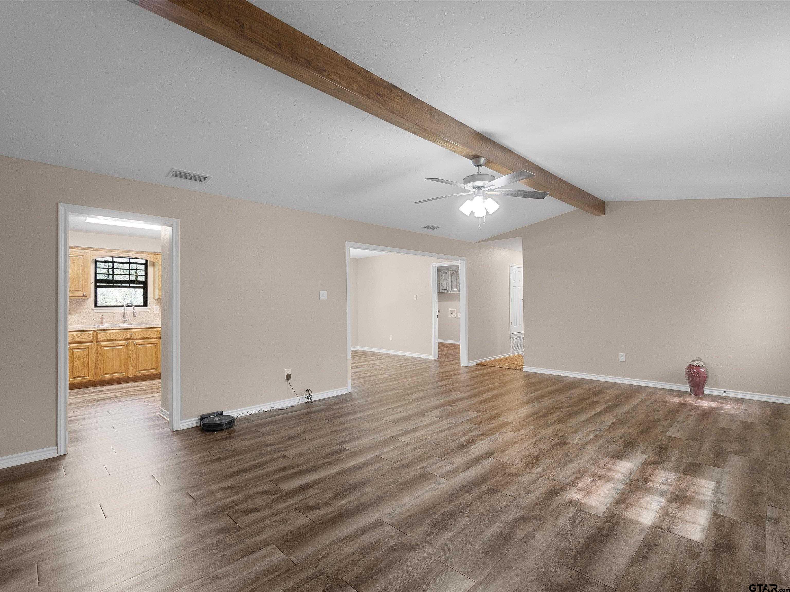 1832 FM 2906 Longview, TX 75603 - Photo 6 of 42 a view of an empty room with wooden floor and a window