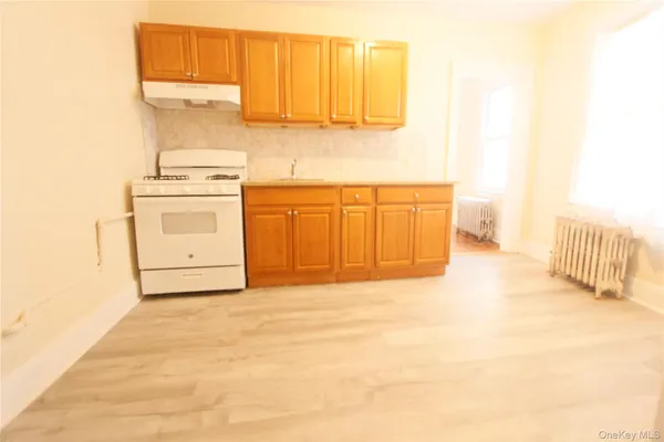 a view of a kitchen with wooden floor