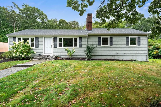 a front view of house with yard and outdoor seating