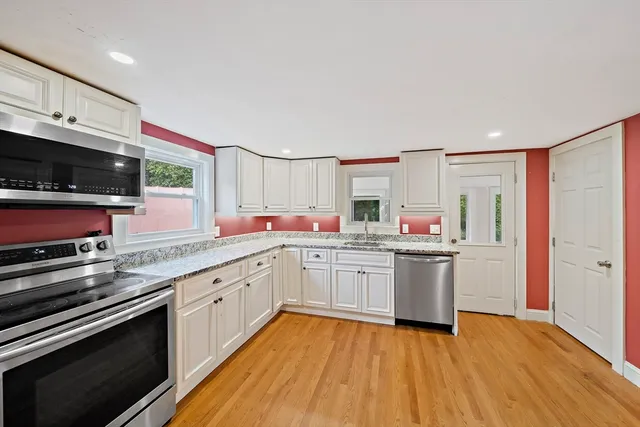 a kitchen with stainless steel appliances granite countertop a sink and stove top oven
