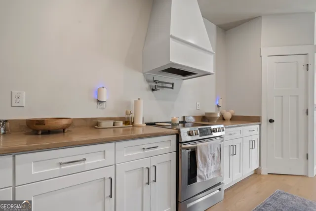 a kitchen with stainless steel appliances granite countertop a sink and a stove