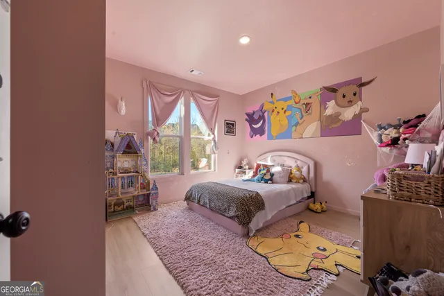 a bedroom with bed and a window