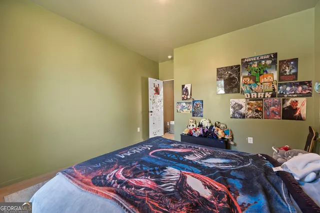 a bedroom with a bed and dresser