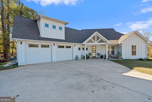 a view of house with yard and a garage