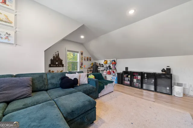 a living room with furniture and a ceiling fan