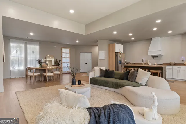 a living room with furniture and kitchen view
