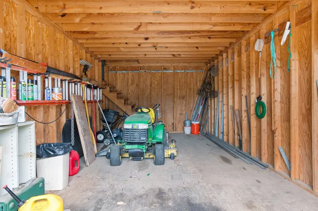 an aerial view of residential house with outdoor space and trees all around