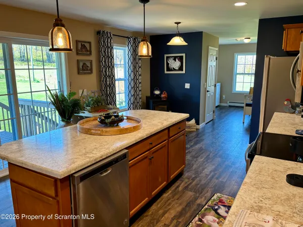 a kitchen with sink cabinets and wooden floor